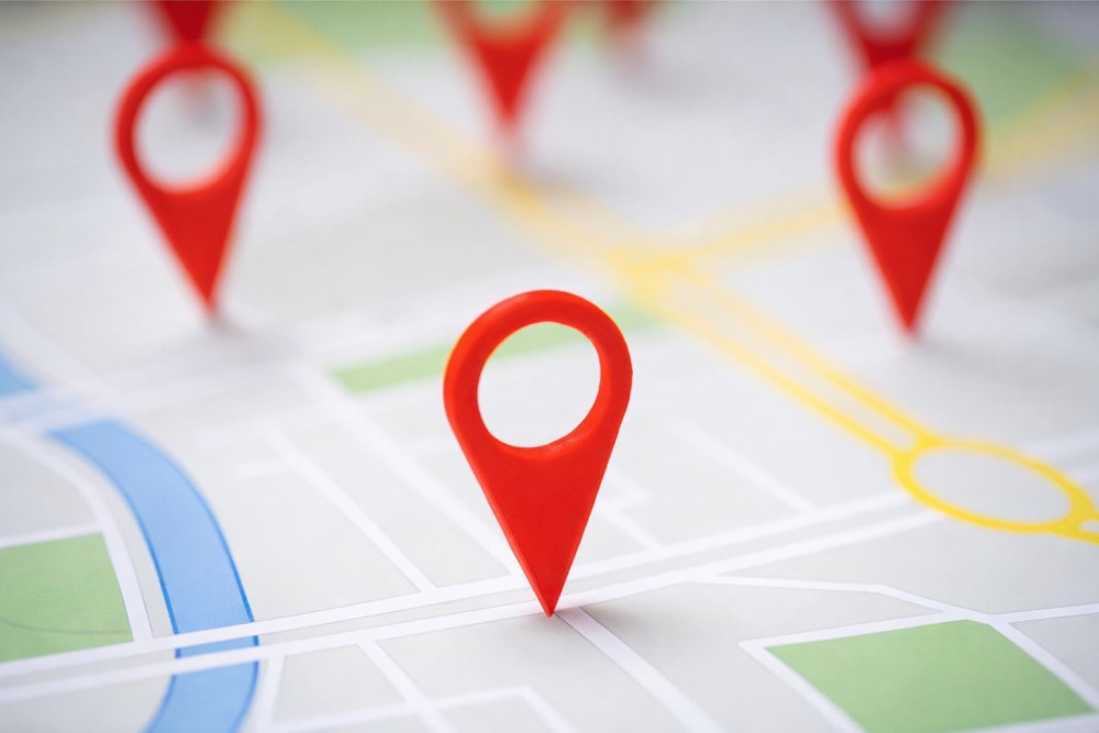 Red map location pins placed across a simplified street map illustration showing destinations